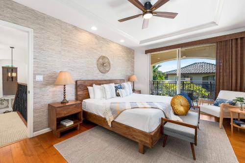 a bedroom with a large bed and a balcony at Mauna Lani Fairways 801 in Waikoloa