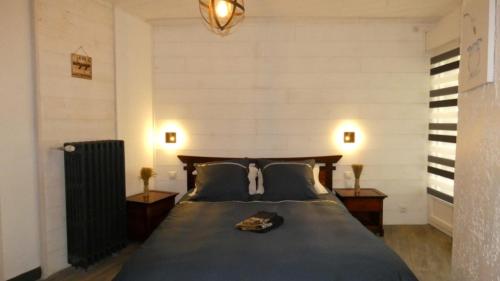 a bedroom with a large bed with two night stands at Domaine Moulin Blanc - Gîte Hermine in Meslan
