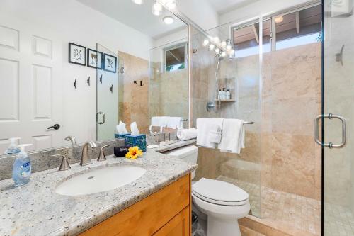 a bathroom with a toilet and a sink and a shower at Mauna Lani Fairways 801 in Waikoloa