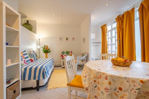 a dining room with a table with a bowl of fruit on it at Campo & Mar Apartments in Porto Moniz