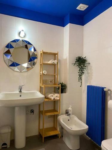 a bathroom with a sink and a toilet and a mirror at Design Villa with parking Navigli Milan sleeps5 in Milan