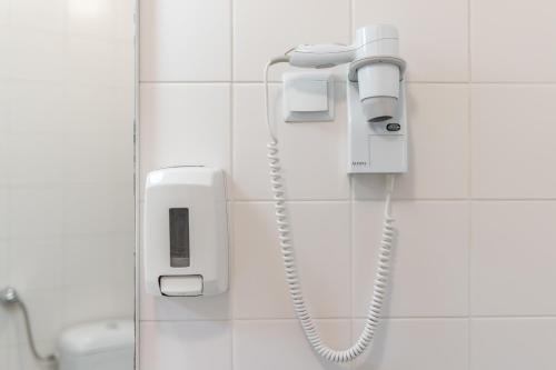 a phone on a wall in a bathroom at Campo & Mar Apartments in Porto Moniz