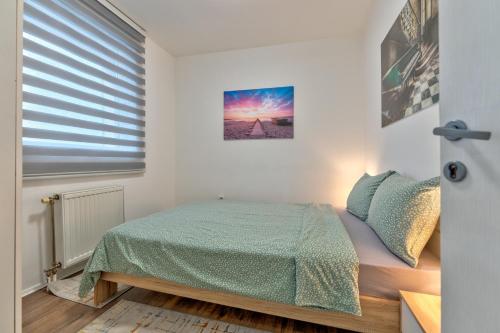 a small bedroom with a bed and a window at White House NS in Novi Sad