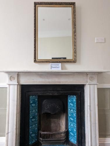 a mirror above a fireplace in a room at The Dulwich in Cheltenham