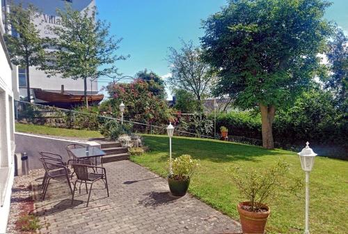 a patio with a table and chairs in a yard at Villa Katharina in Sassnitz