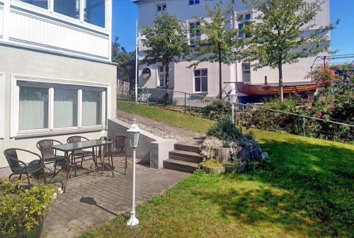 un patio con mesa y sillas junto a un edificio en Villa Katharina en Sassnitz