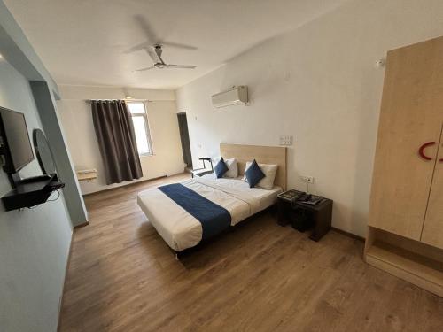 a hotel room with a bed and a television at Hotel Luxurs a unit of knights in Jaipur