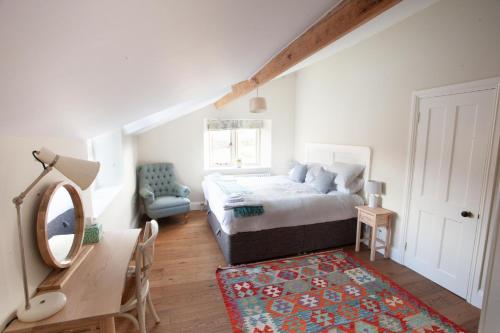 a bedroom with a bed and a desk and a mirror at An 8 Bed Luxury Farmhouse 