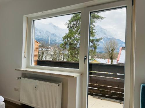 a window with a view of a mountain at The View Apartment in Garmisch-Partenkirchen