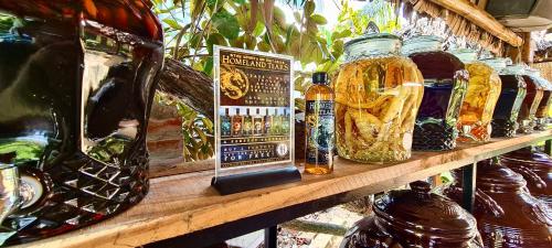 a shelf with many glass jars on it at Song Ngư Riverside Homestay in Can Tho