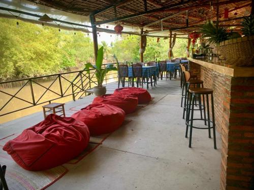 a row of red sleeping bags on a patio at Song Ngư Riverside Homestay in Can Tho