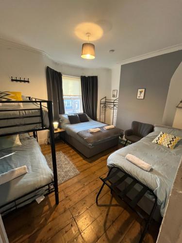 a living room with bunk beds and a couch at Rooms Anfield- 5 mins from LFC in Liverpool