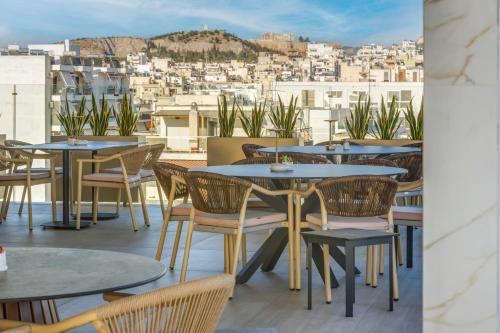 a row of tables and chairs on a roof at LUX&EASY Signature Syggrou 234 in Athens