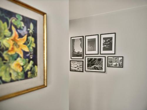 a group of pictures hanging on a wall at The Tauplitz Suites - Alpine Suite B4 by AA Holiday Homes in Tauplitz