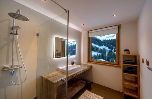 a bathroom with a sink and a glass shower at Chalet Gargellen in Gargellen