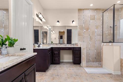 a bathroom with two sinks and a shower at Randolph Central Location, 1-story, Chef Kitchen, Creekside in Selma