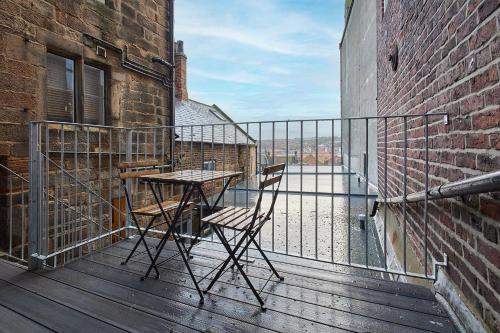 a balcony with a table and chairs on a building at Host & Stay - Flowergate Apartments in Whitby