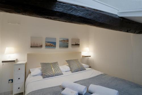 a bedroom with a bed and two pillows at Pied-a-terre Saint Michel in Menton