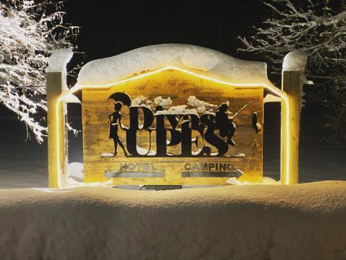 a sign for a hockey game is covered in snow at Divas Upes in Koknese