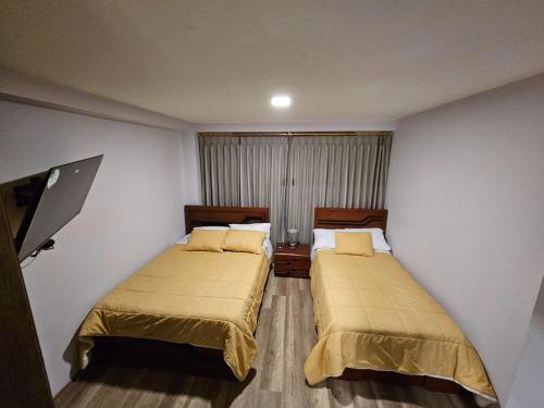 a room with two beds in a room at New Dawn Rio in Riobamba
