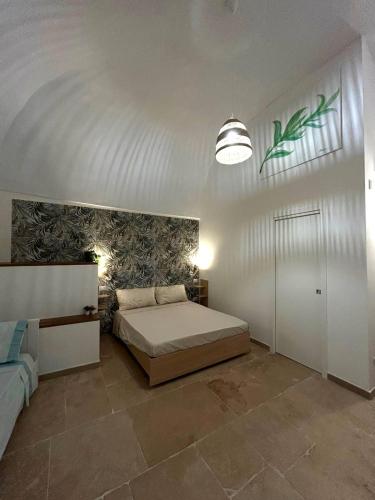 a bedroom with a bed and a wall with a plant mural at Meridiem in Molfetta