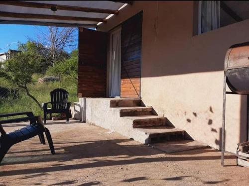 une terrasse couverte d'une maison avec un banc et des escaliers dans l'établissement Casa en Cabalango, à Cavalango
