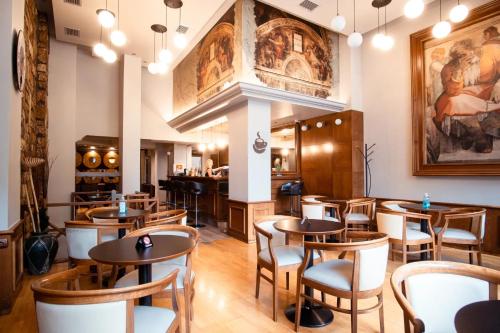 a restaurant with tables and chairs and a bar at Athens City Hotel in Athens