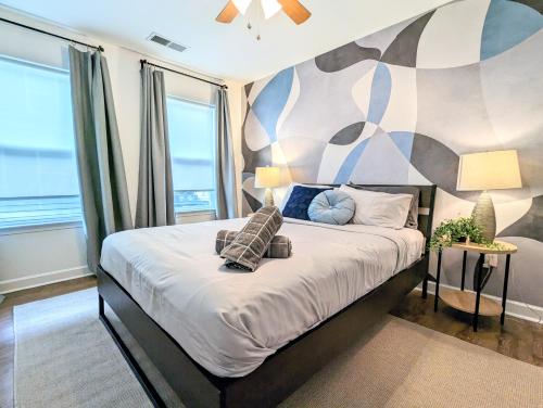 a bedroom with a large bed with a mural at League Flats West End in Charlotte