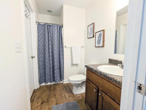 a white bathroom with a sink and a toilet at League Flats West End in Charlotte