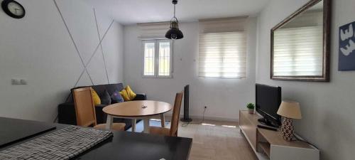 a living room with a table and a dining room at Precioso apartamento recién reformado in Madrid