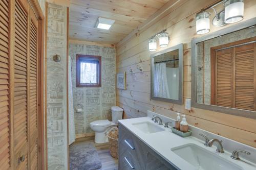 a bathroom with a sink and a toilet and a mirror at Deep Gap Cabin with 2 Decks and Community Amenities! in Powderhorn Mountain