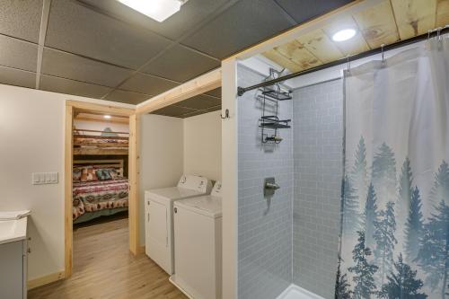 a bathroom with a shower and a washer and dryer at Deep Gap Cabin with 2 Decks and Community Amenities! in Powderhorn Mountain