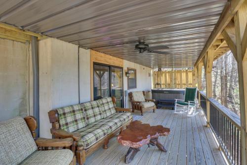 a screened in porch with a couch and a table at Deep Gap Cabin with 2 Decks and Community Amenities! in Powderhorn Mountain