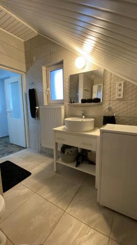 a bathroom with a sink and a mirror at Sweet Home Apartman in Balatonfüred