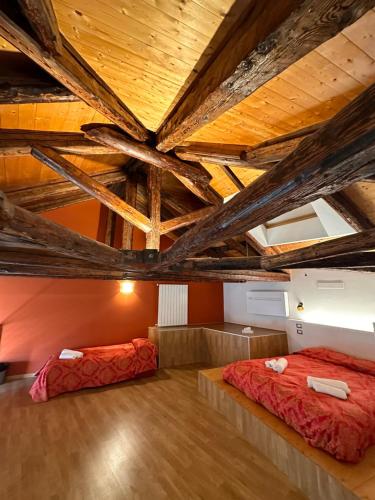 2 letti in una camera con soffitti in legno di Collegio AMDG a Venezia