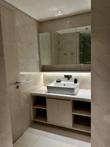 a bathroom with a sink and a mirror at Cassia Residences in Phuket