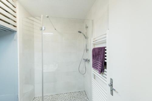 a bathroom with a shower with a glass door at Studio Barèges ski, rando, cure in Barèges