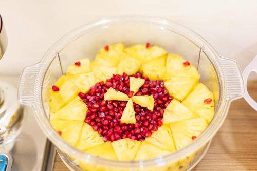 a food processor with fruit in a bowl on a table at ESAA Airport Hotel in Cochin