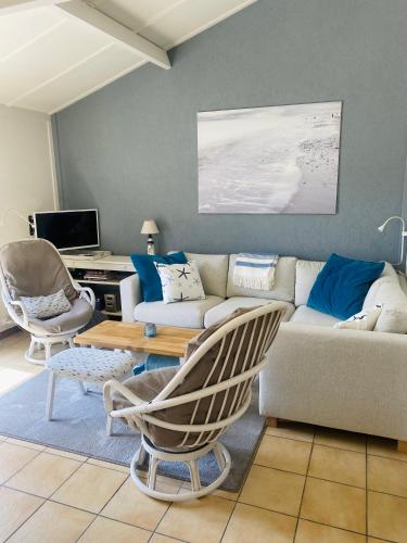 a living room with a couch and a table at Zeepark Zeewind in Bredene
