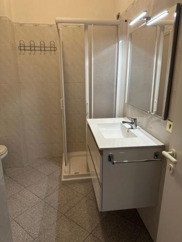 a bathroom with a sink and a shower at Appartamento Porto Azzurro 5/6 beds in Porto Azzurro