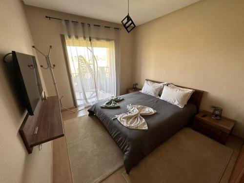 a bedroom with a bed with a robe on it at Prestigia appartement de lux in Marrakesh