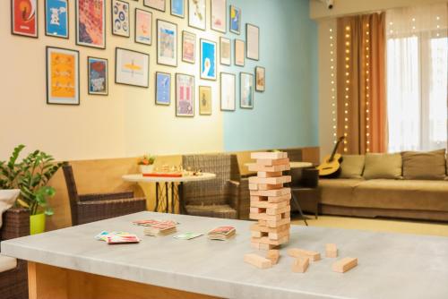 a living room with a table with blocks on it at Bodo Hostel in Bishkek