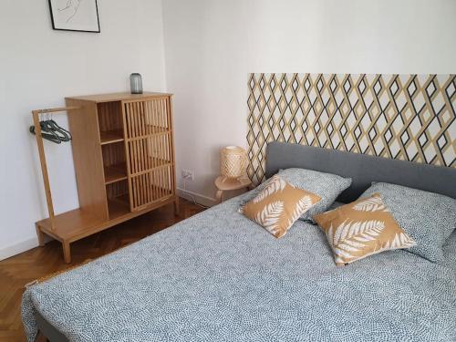 a bedroom with a bed with two pillows on it at Suite Forum Vue Imprenable in Reims