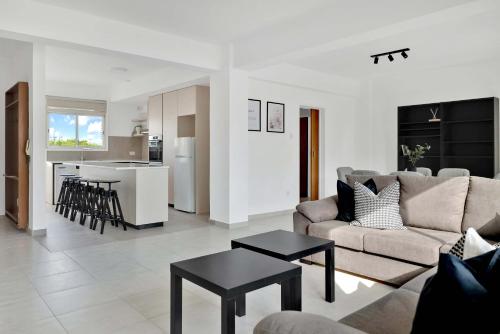 a living room with a couch and a table at Phaedrus Living: Romanou Modern City Center Flat in Nicosia