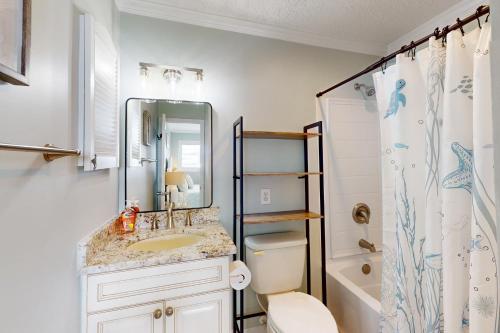 a bathroom with a sink and a toilet and a shower at CAB03 Pelicans Penthouse in Oak Island