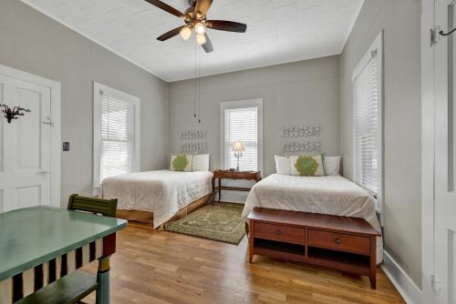 a bedroom with two beds and a ceiling fan at Austin Haus in Fredericksburg