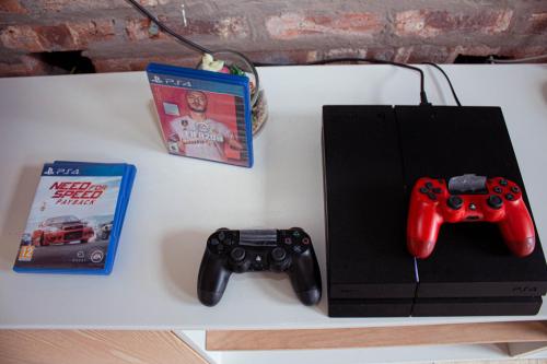 a table with two video game controllers and a book at Amabwe Guesthouse in Grahamstown