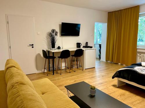 a living room with a couch and a table at Studio Apartment Dandelion in Bratislava