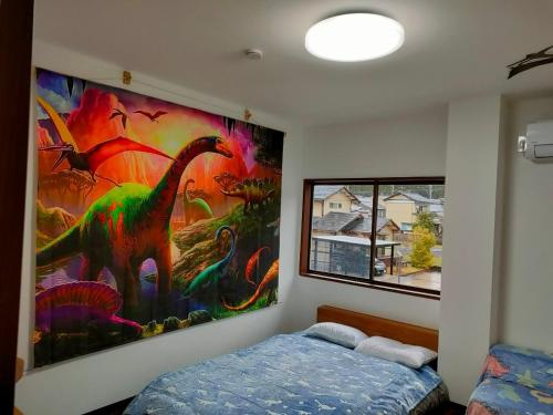 Postel nebo postele na pokoji v ubytování 11月フルリフォーム 12月オープン恐竜一色ゲストハウスDinosaur Guesthouse
