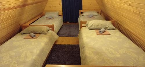 two twin beds sitting in a room with at Planinski Mir in Pale